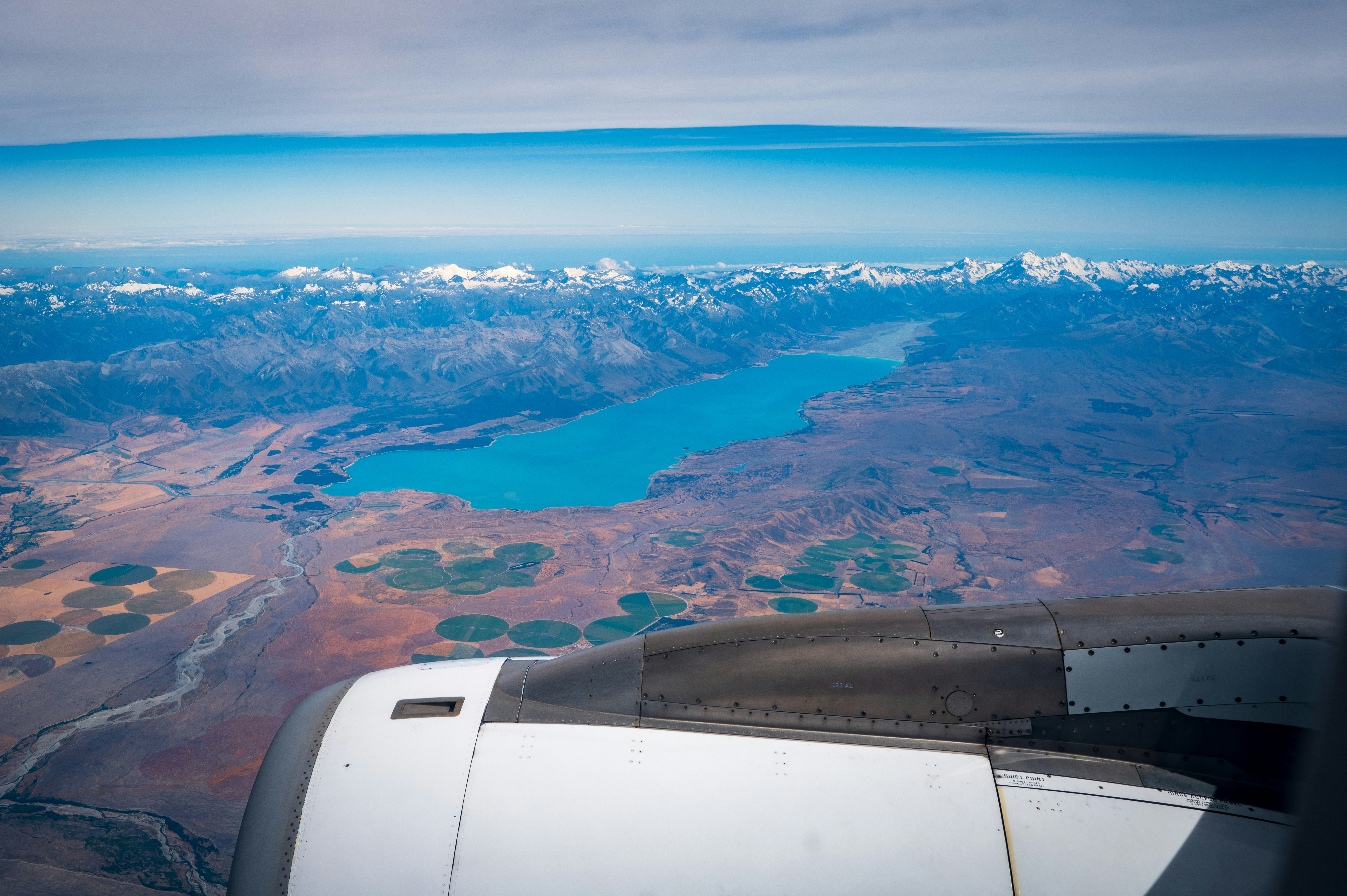 a view from a plane of a lake and mountains