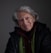 an older woman in a black jacket and green jacket