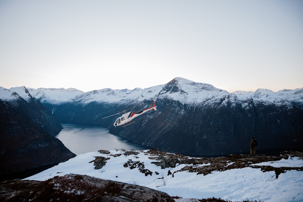 a helicopter that is flying over a mountain