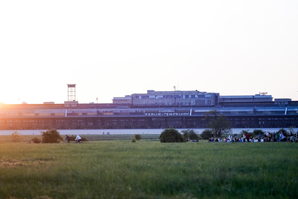 a grassy field with a building in the background