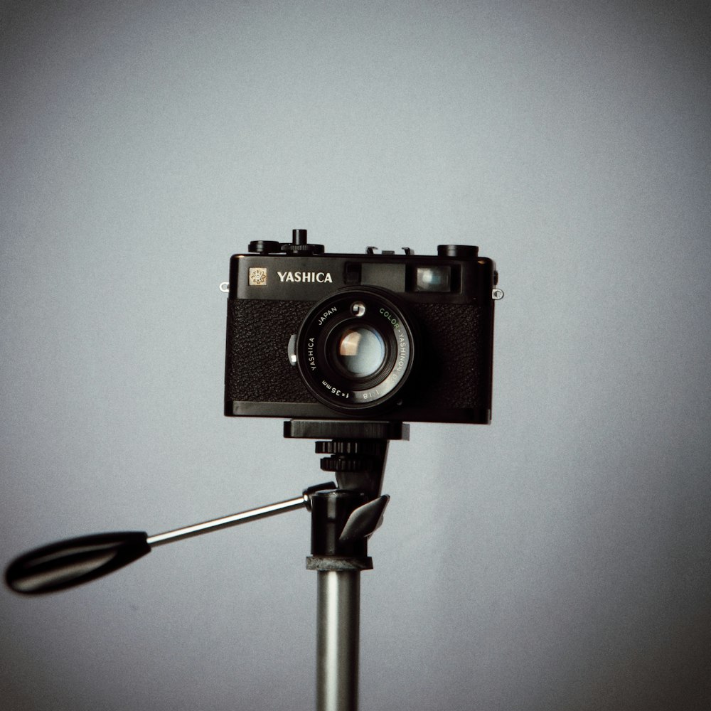 a black camera sitting on top of a tripod