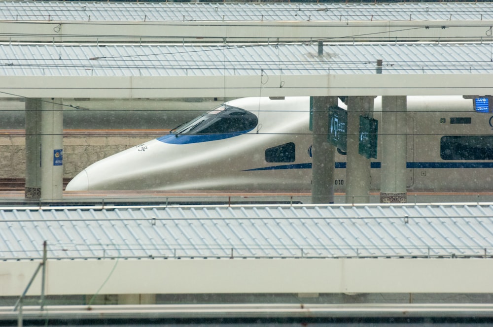 a high speed train traveling through a train station