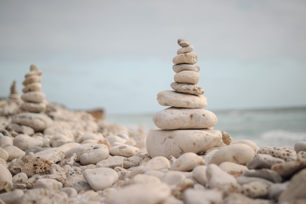 a stack of rocks sitting on top of a beach