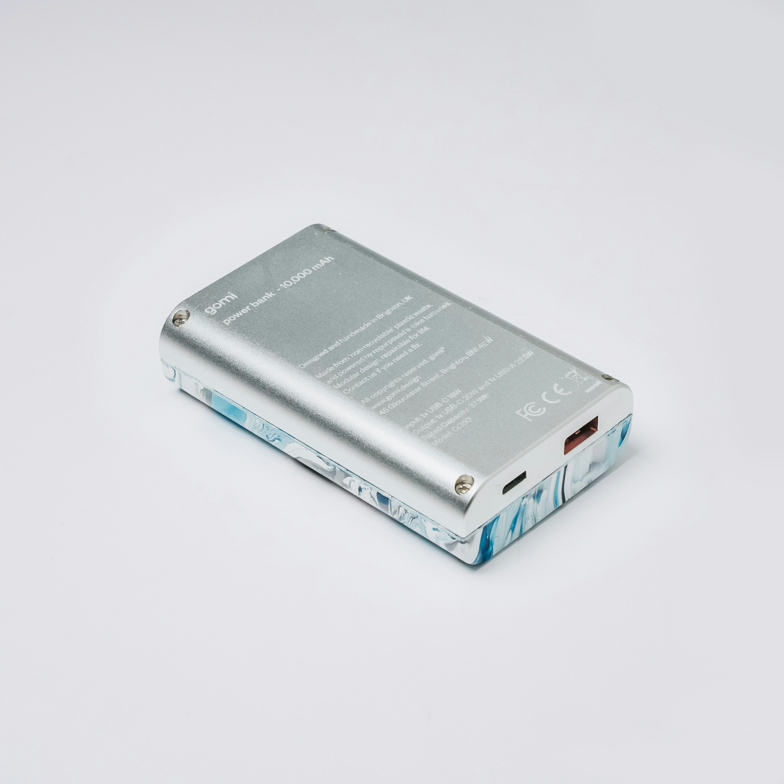 a silver cell phone sitting on top of a white table