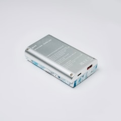 a silver cell phone sitting on top of a white table