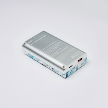 a silver cell phone sitting on top of a white table
