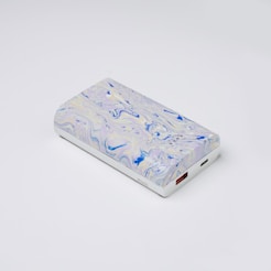a white and blue case sitting on top of a white table