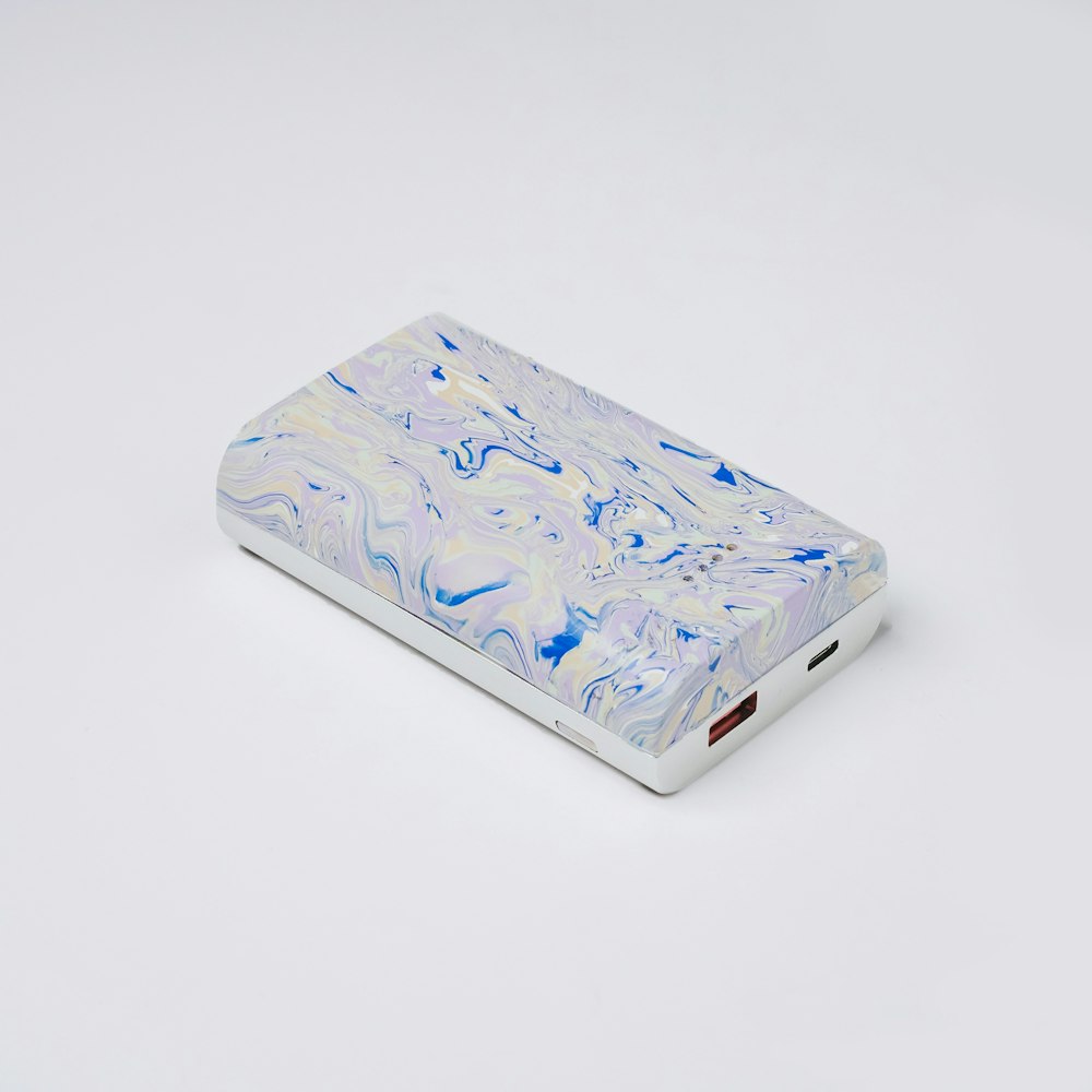 a white and blue case sitting on top of a white table