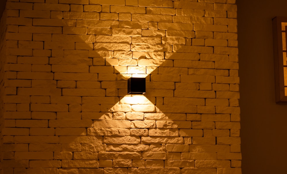 a brick wall with a light shining on it