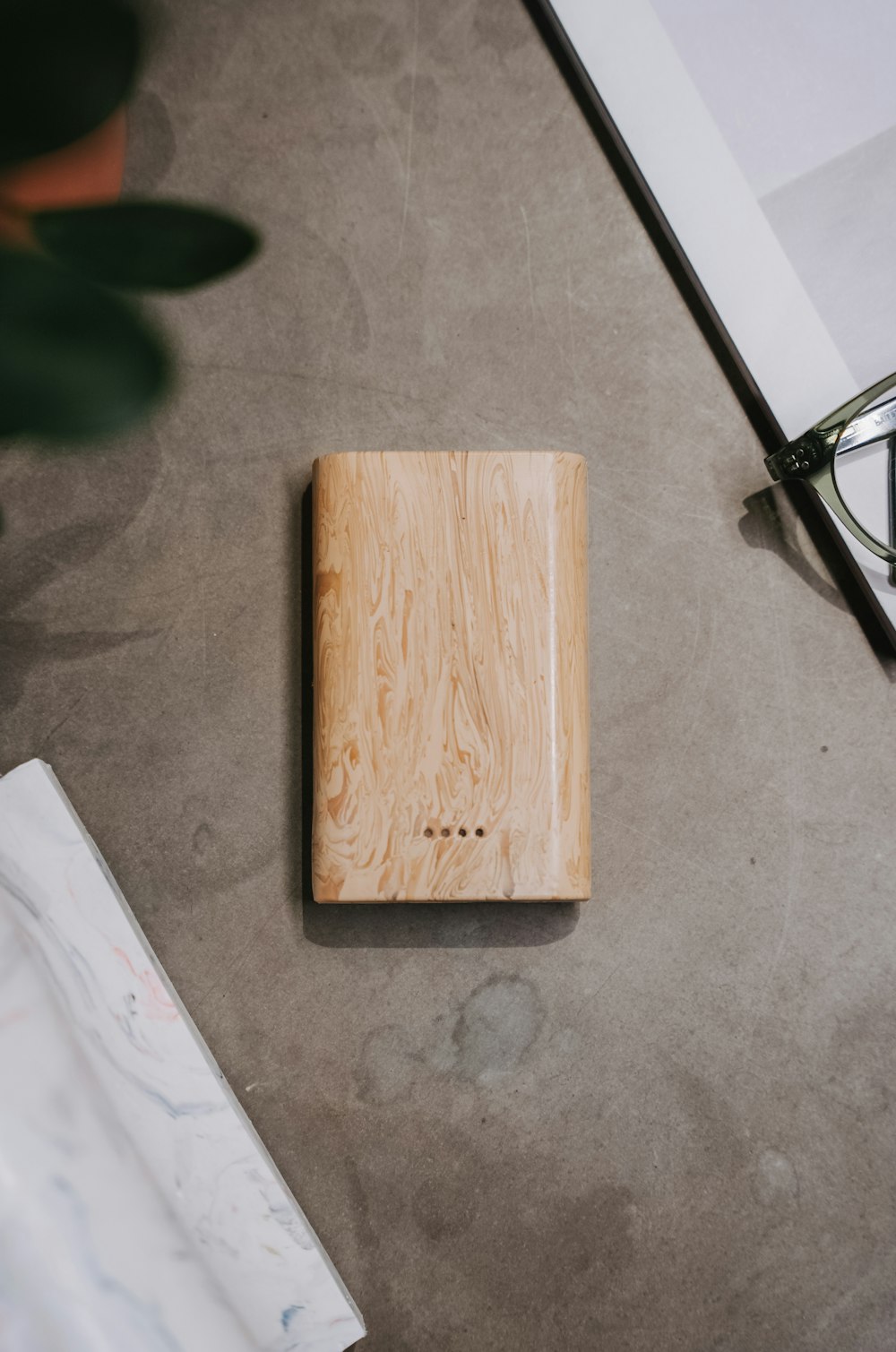 a wooden box sitting on top of a table next to a pair of glasses