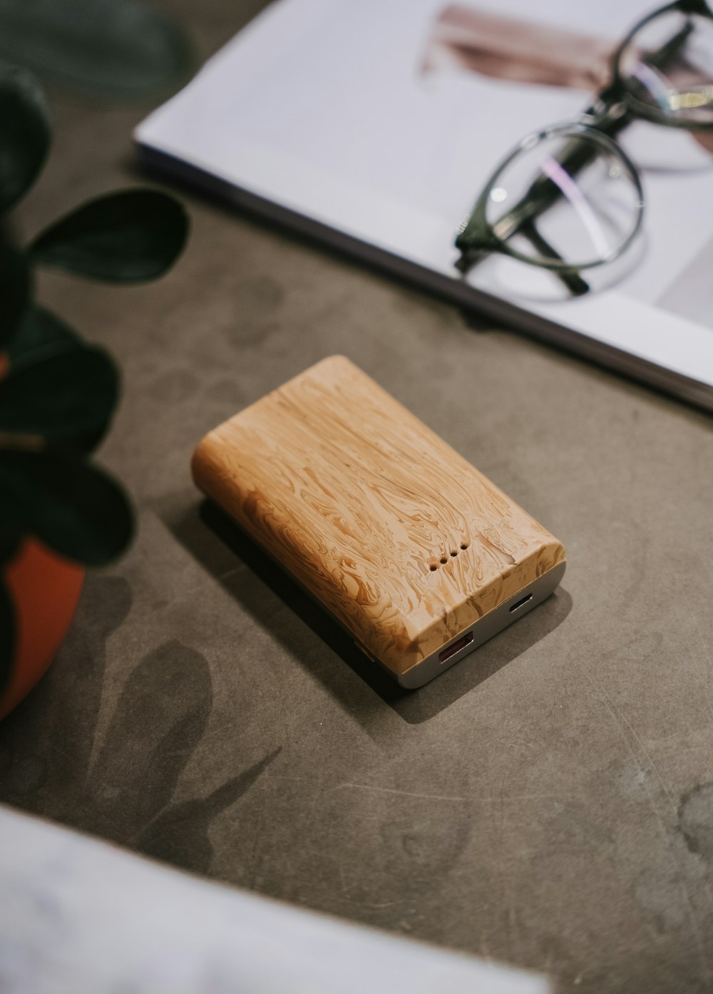 a wooden case sitting on top of a table next to a pair of glasses