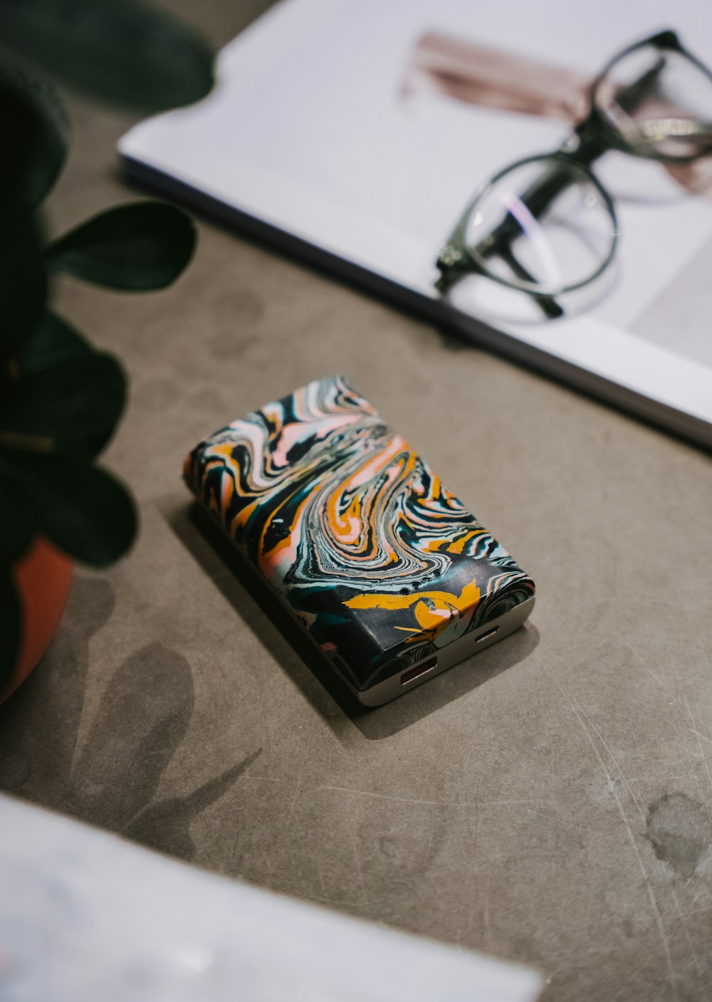 a lighter sitting on a table next to a pair of glasses