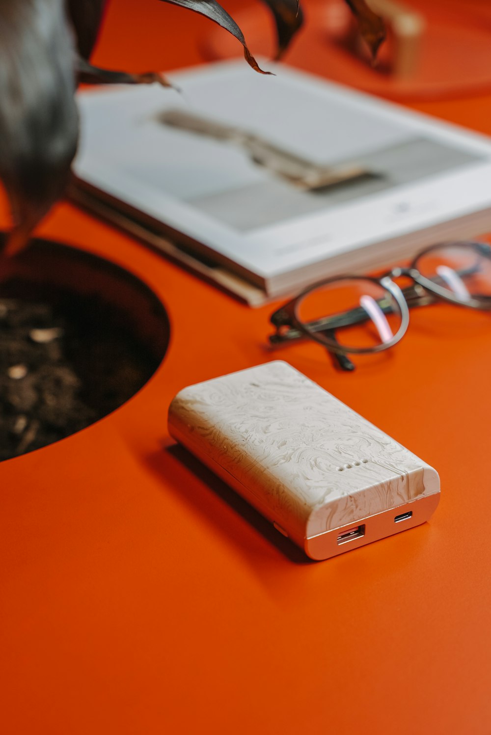 a cell phone sitting on top of a table next to a pair of glasses