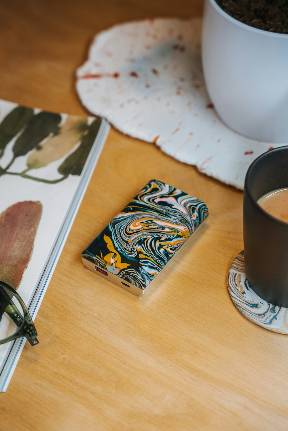 a cup of coffee sitting next to a book on a table