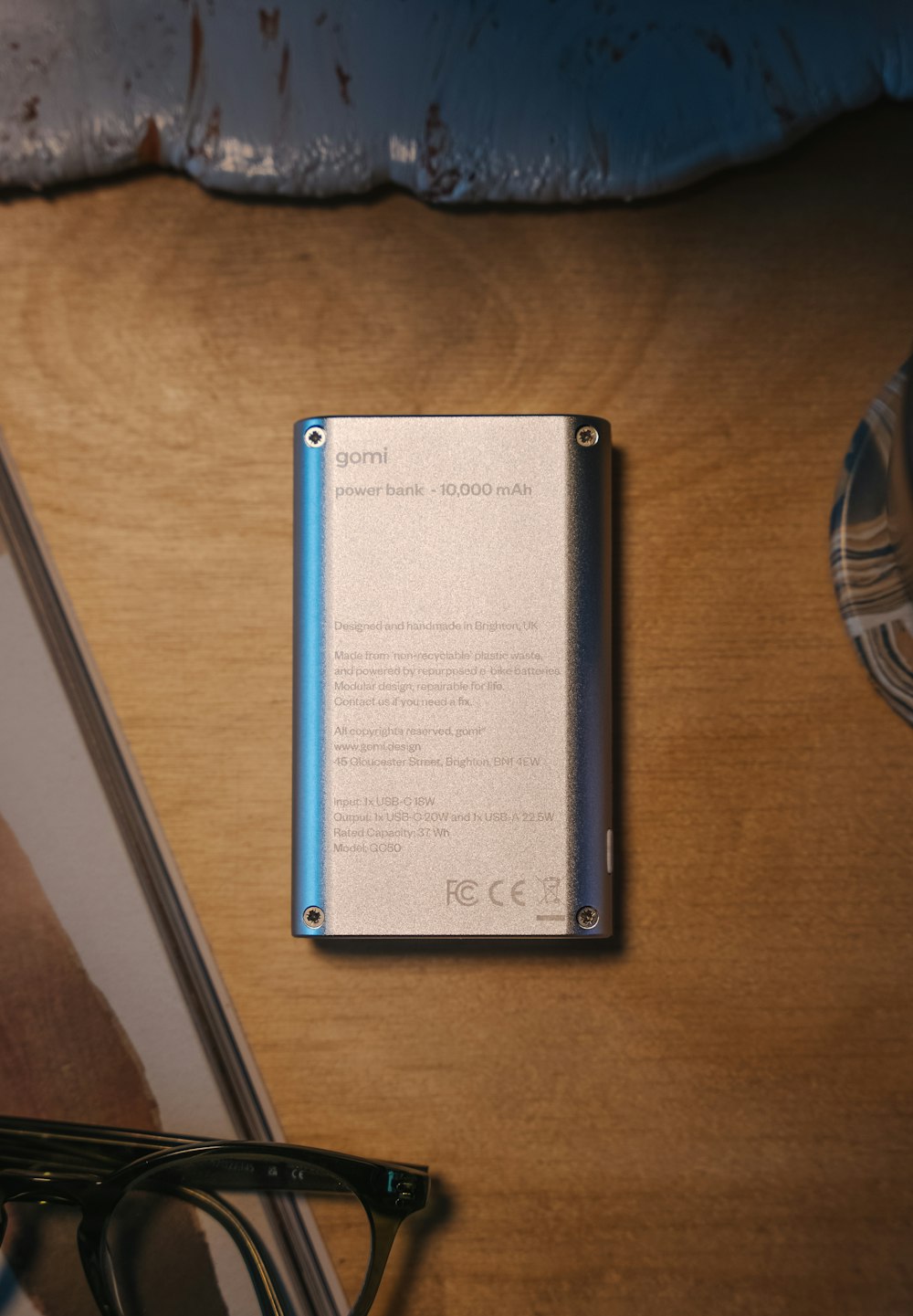 a metal device sitting on top of a table next to a pair of glasses