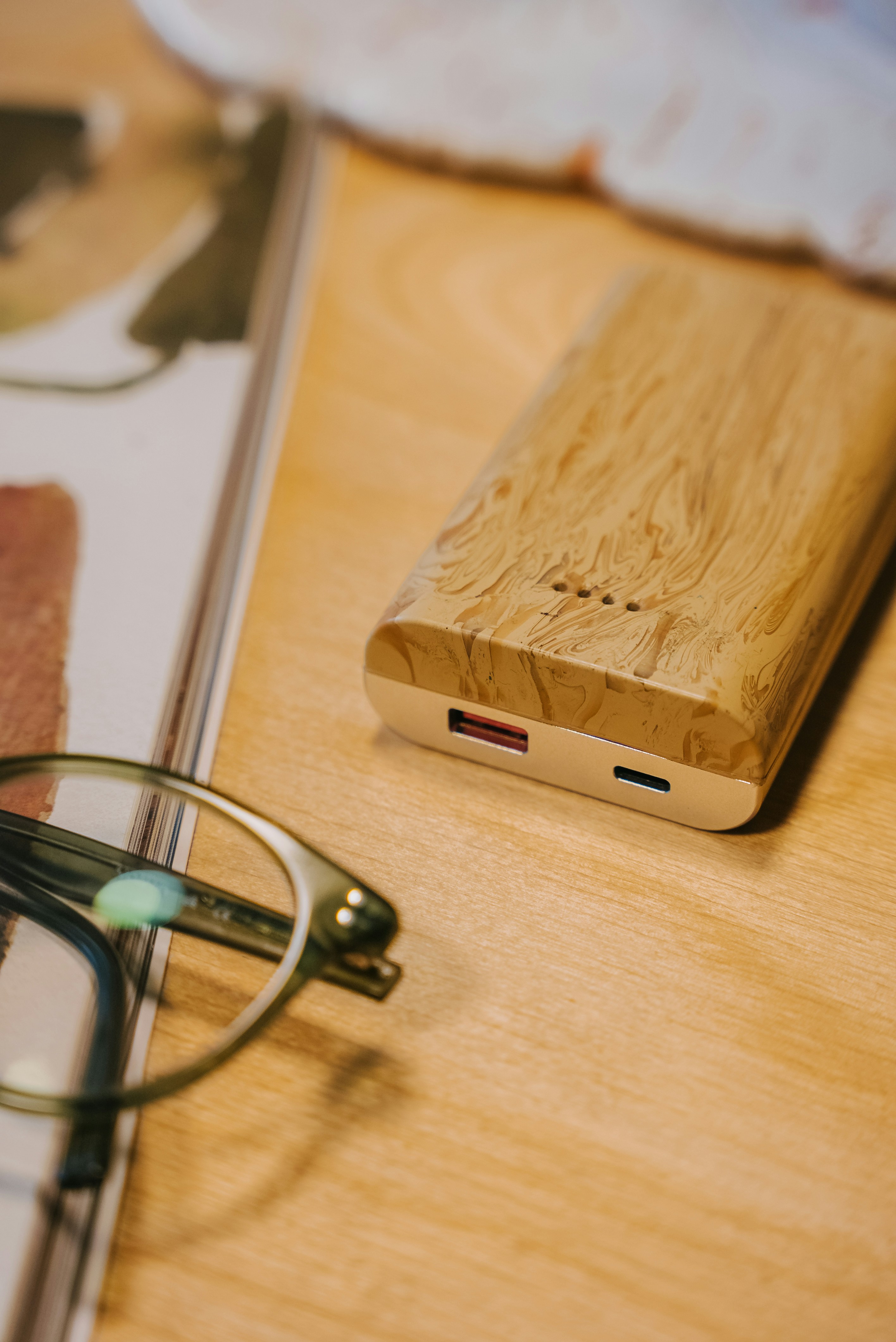 a pair of glasses sitting on top of a wooden table