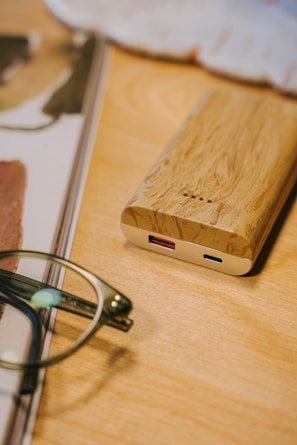 a pair of glasses sitting on top of a wooden table