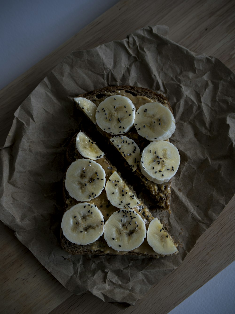 a piece of bread with sliced bananas on it