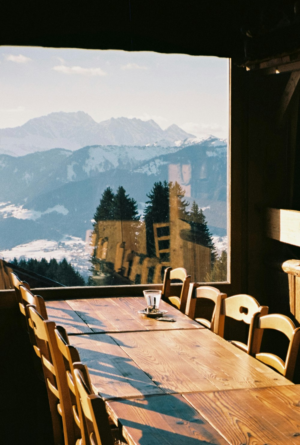 a long wooden table with a view of a mountain range