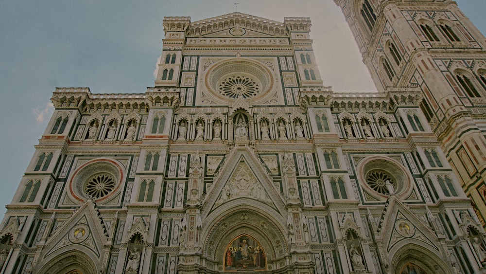 a very tall cathedral with a clock on it's side