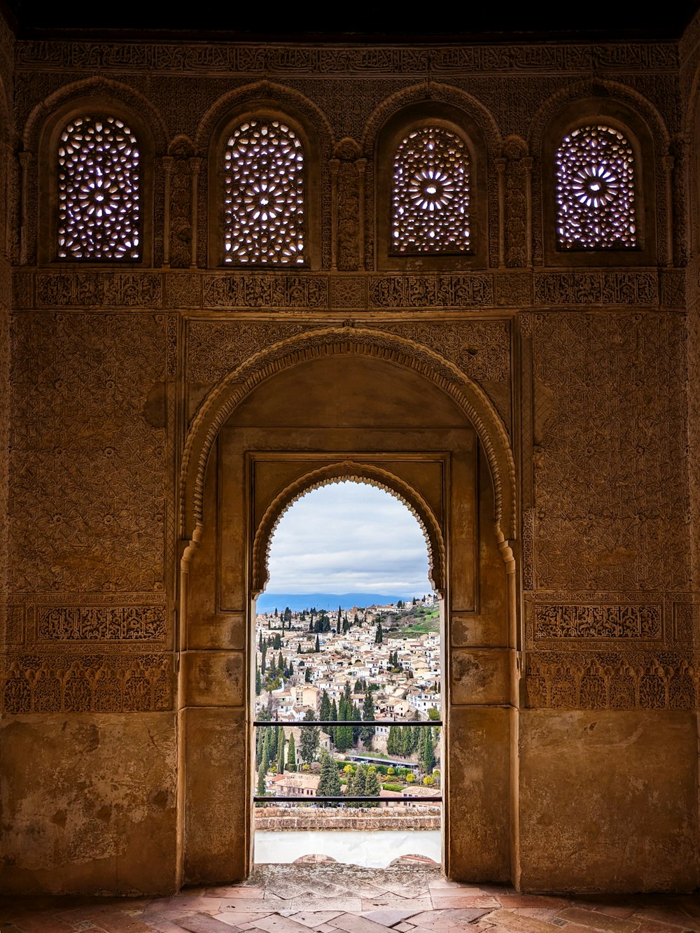 an archway with a view of a city in the distance