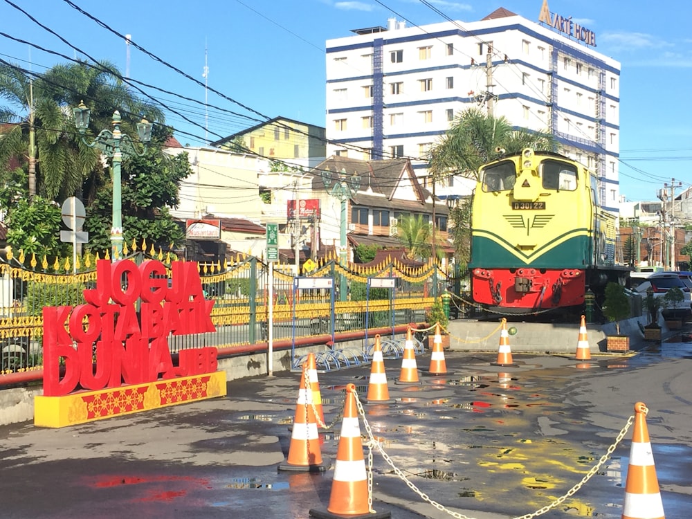 a yellow and green train traveling down train tracks