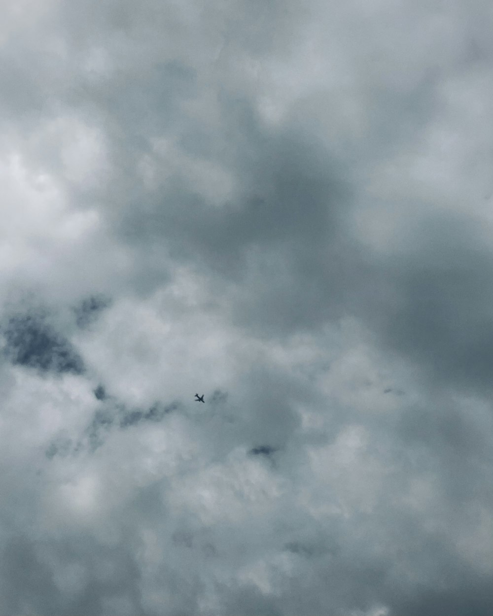 a plane is flying through a cloudy sky