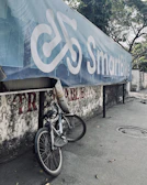 a bike parked next to a wall with a sign on it