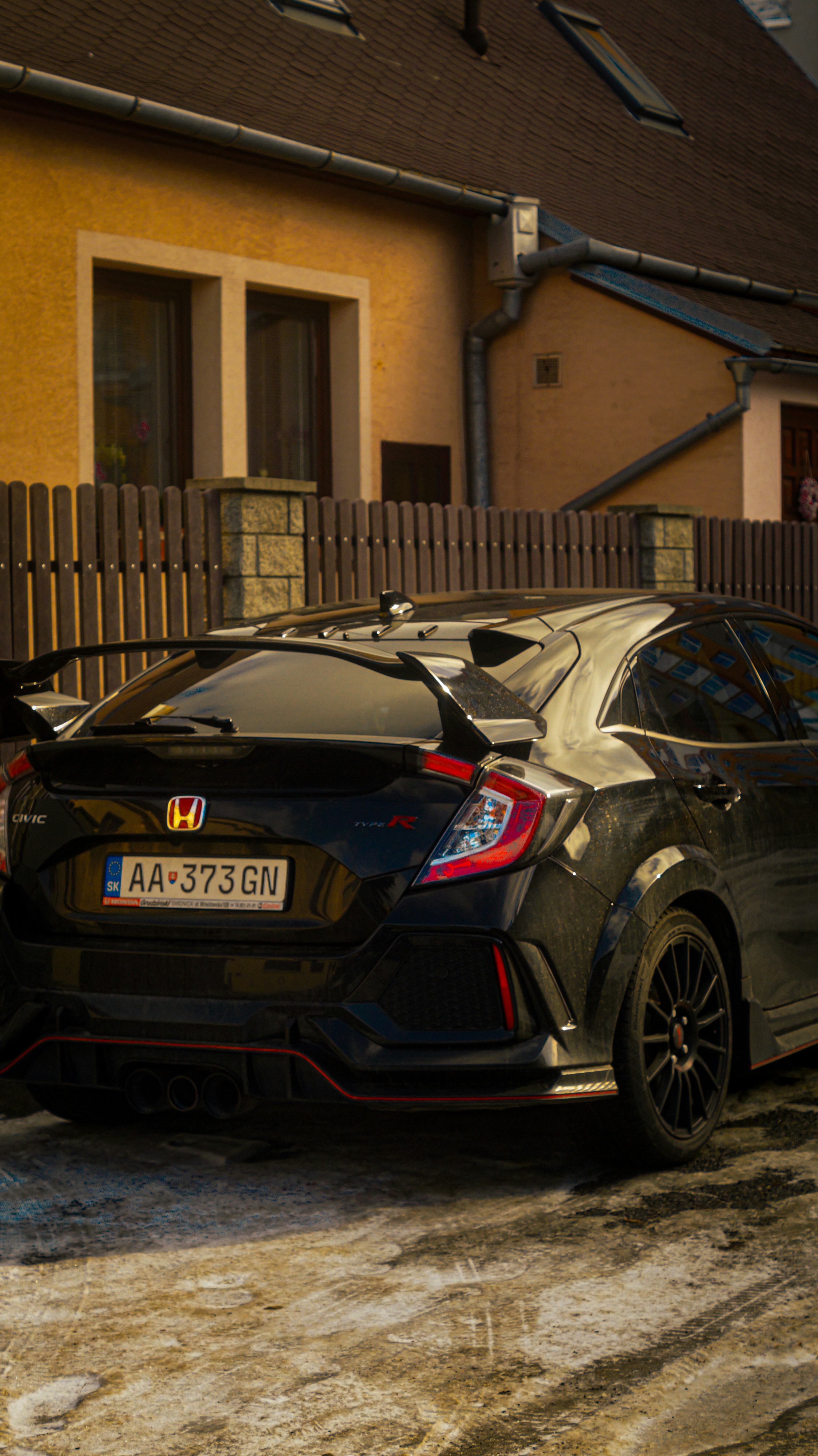 a couple of cars parked in front of a house