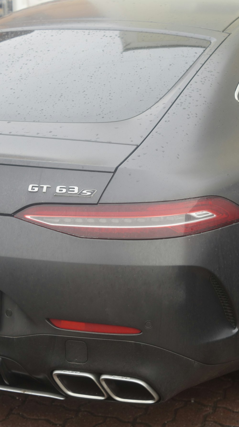 the rear end of a grey sports car