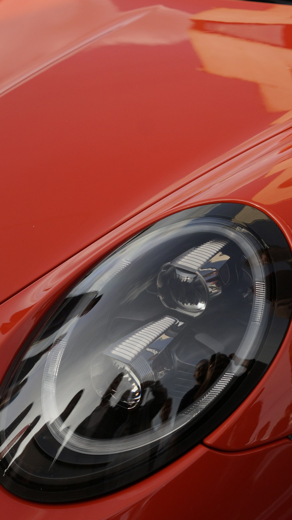 a close up of a red sports car headlight