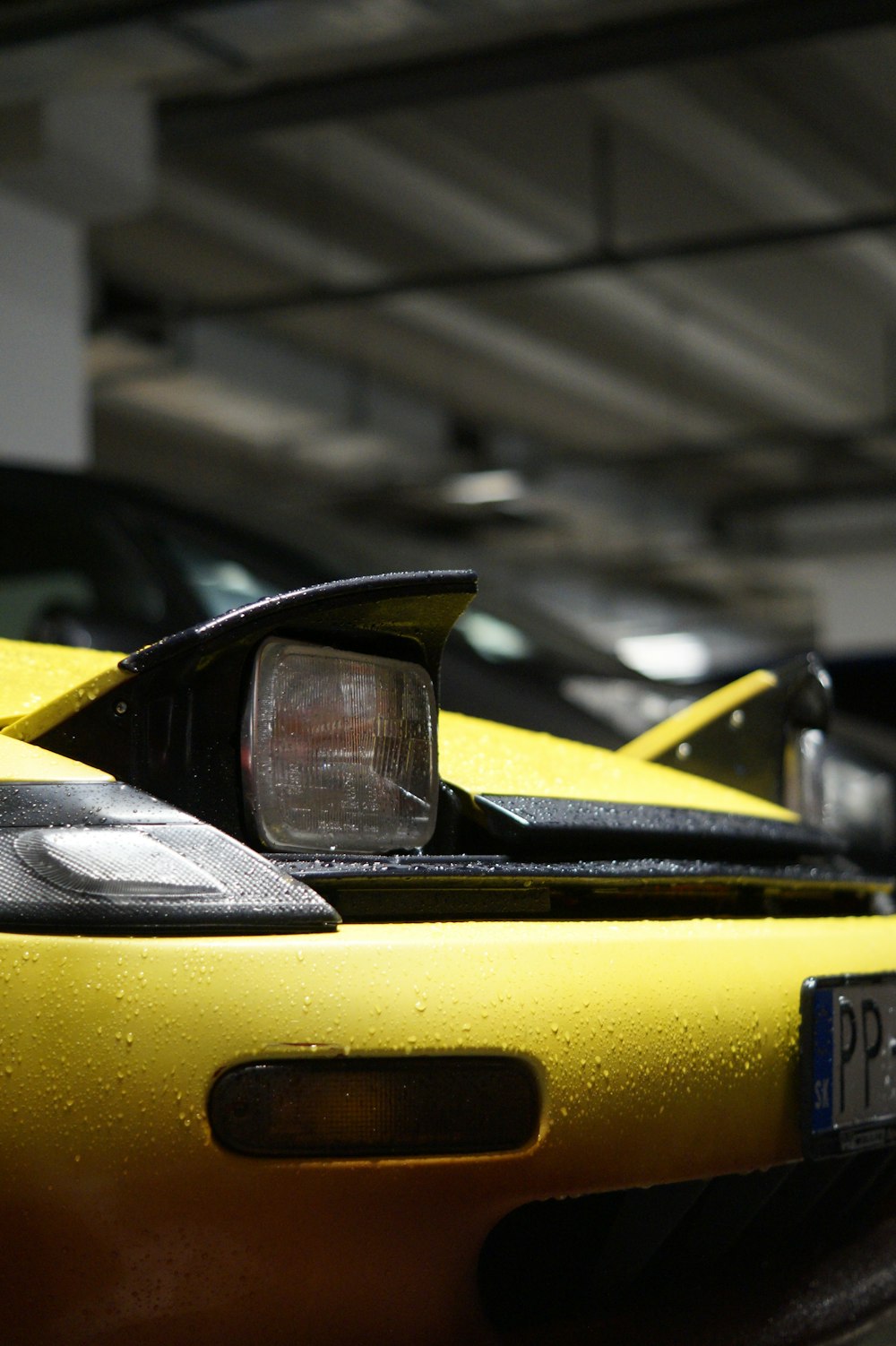 a row of yellow sports cars in a parking garage