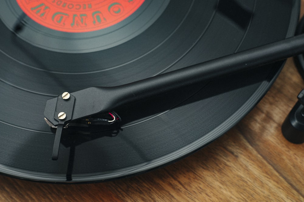 a close up of a record player on a wooden table