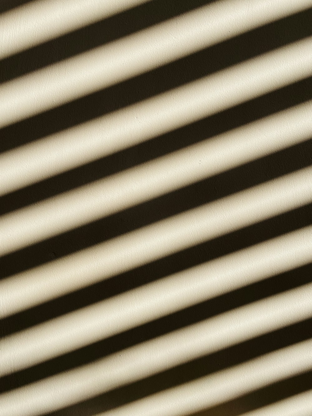 a close up of a black and white striped blind