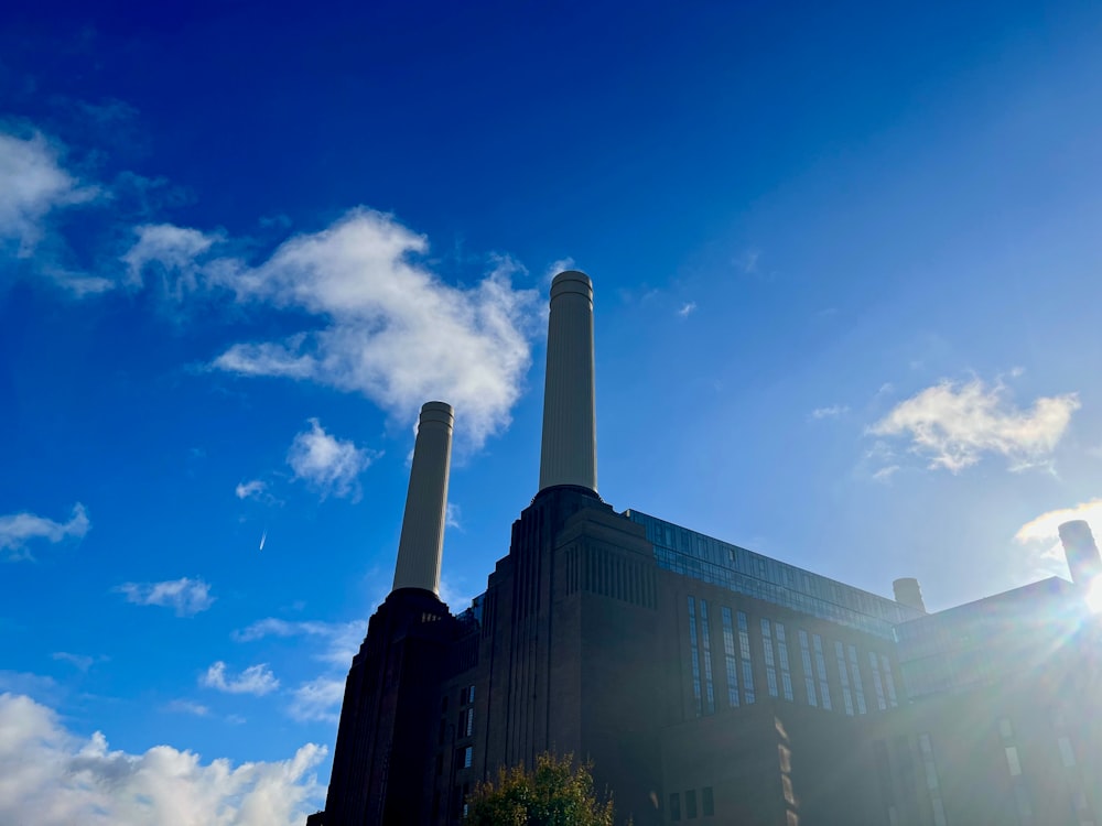 a factory building with two smoke stacks in the background