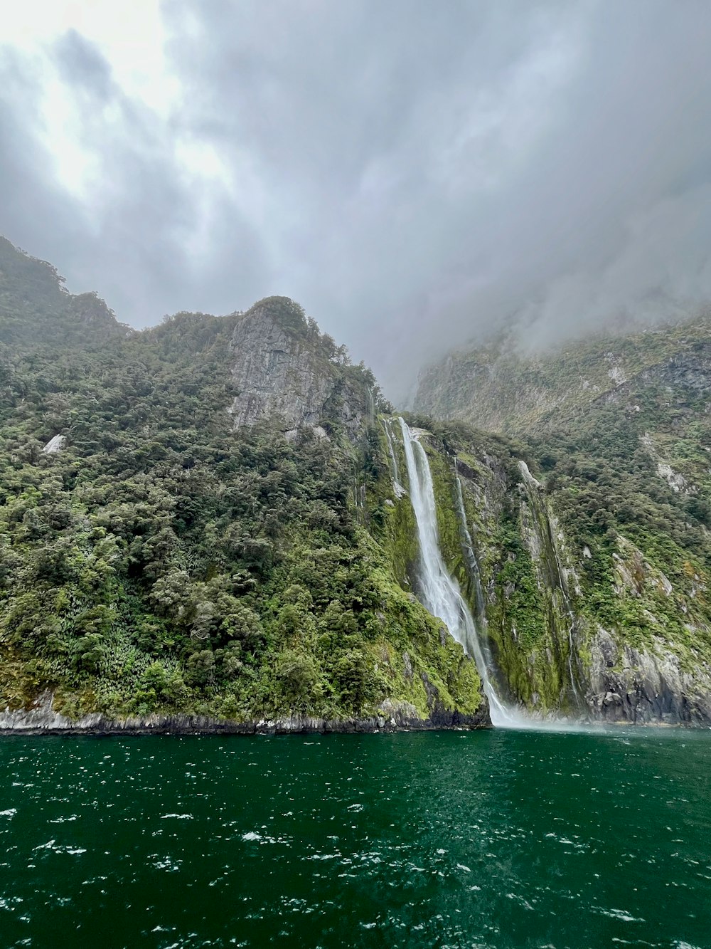 a waterfall in the middle of a body of water