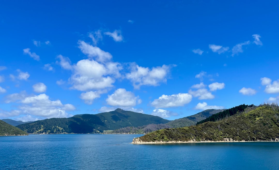 a large body of water surrounded by mountains,