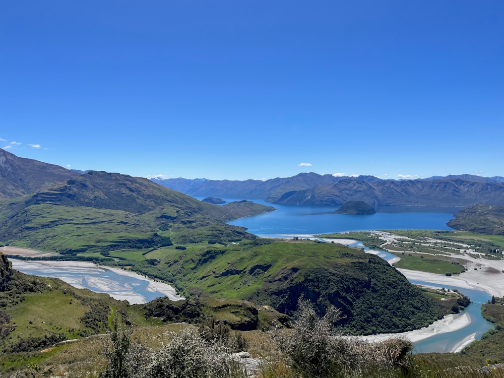 a scenic view of a river and mountains