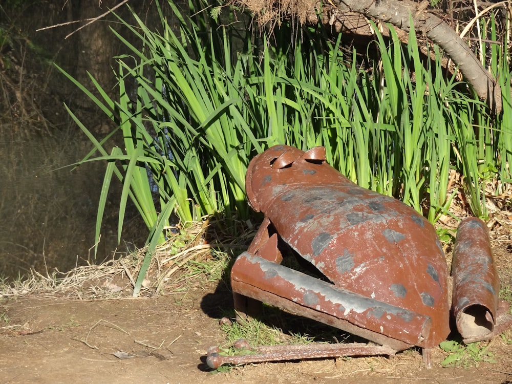 a rusted metal object laying on the ground