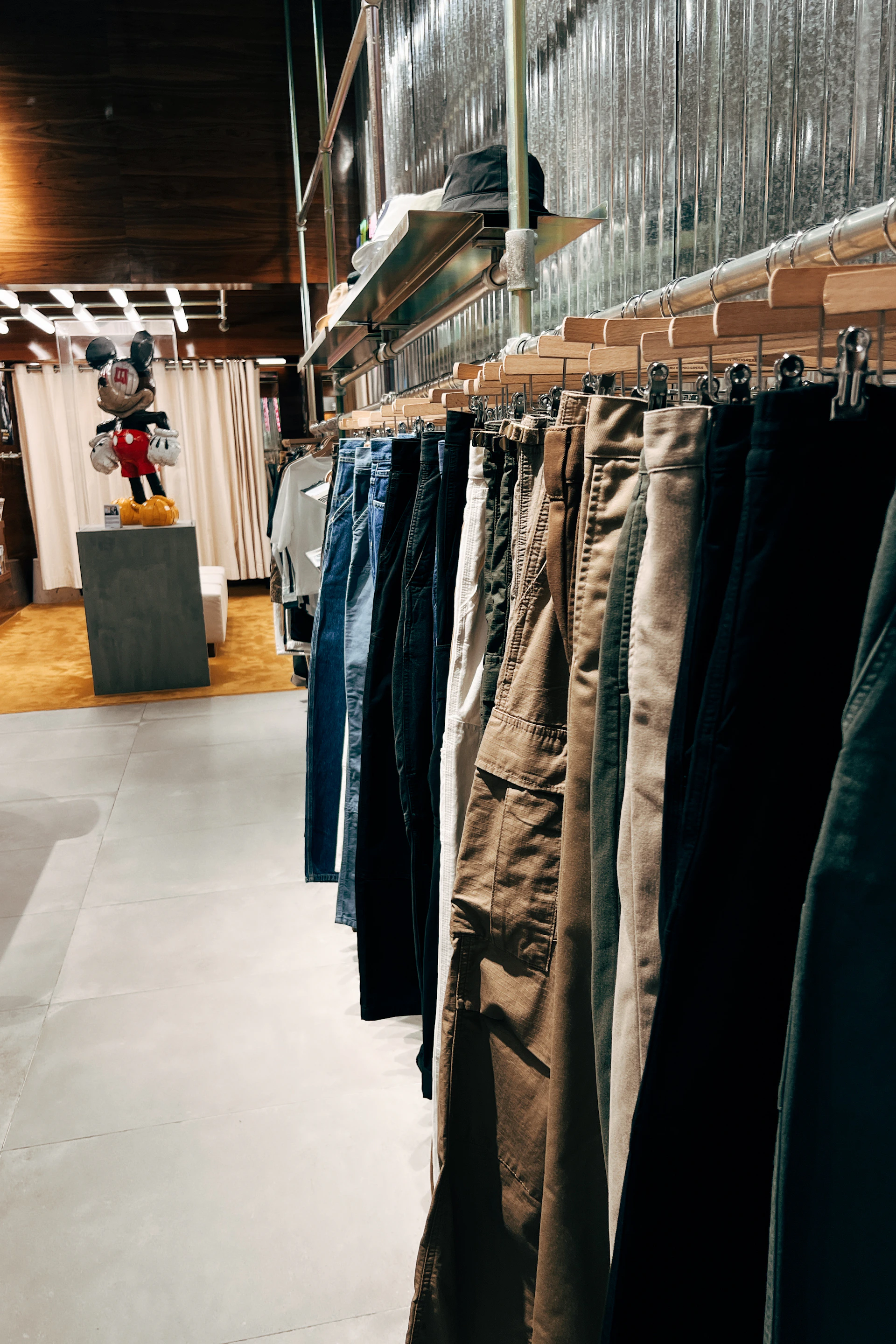 a row of pants hanging on a rack in a store