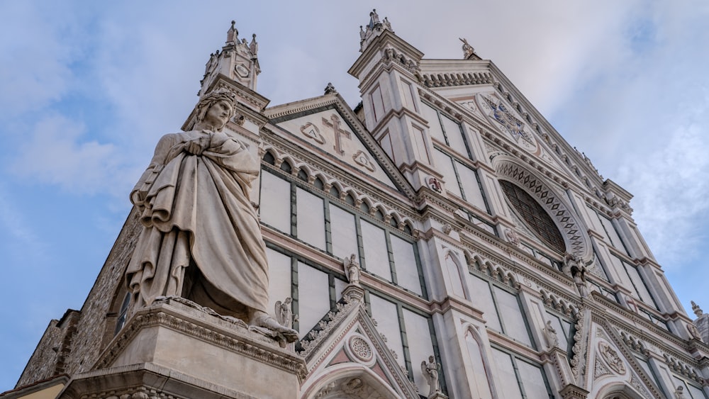 a tall building with a statue on the front of it