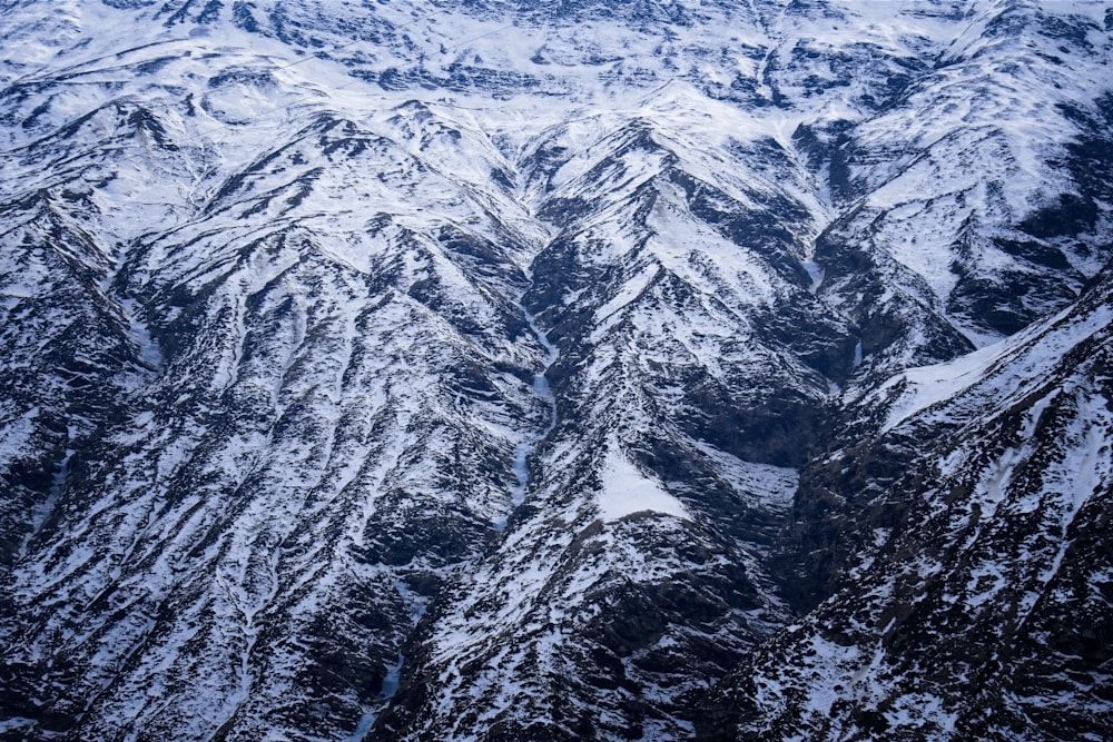 a view of a snowy mountain range from an airplane