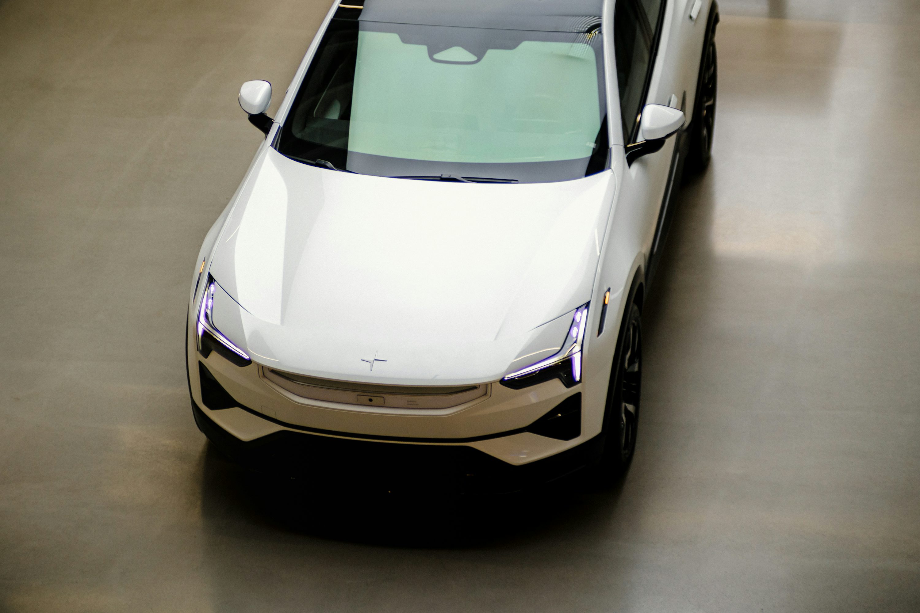 a white car parked inside of a building