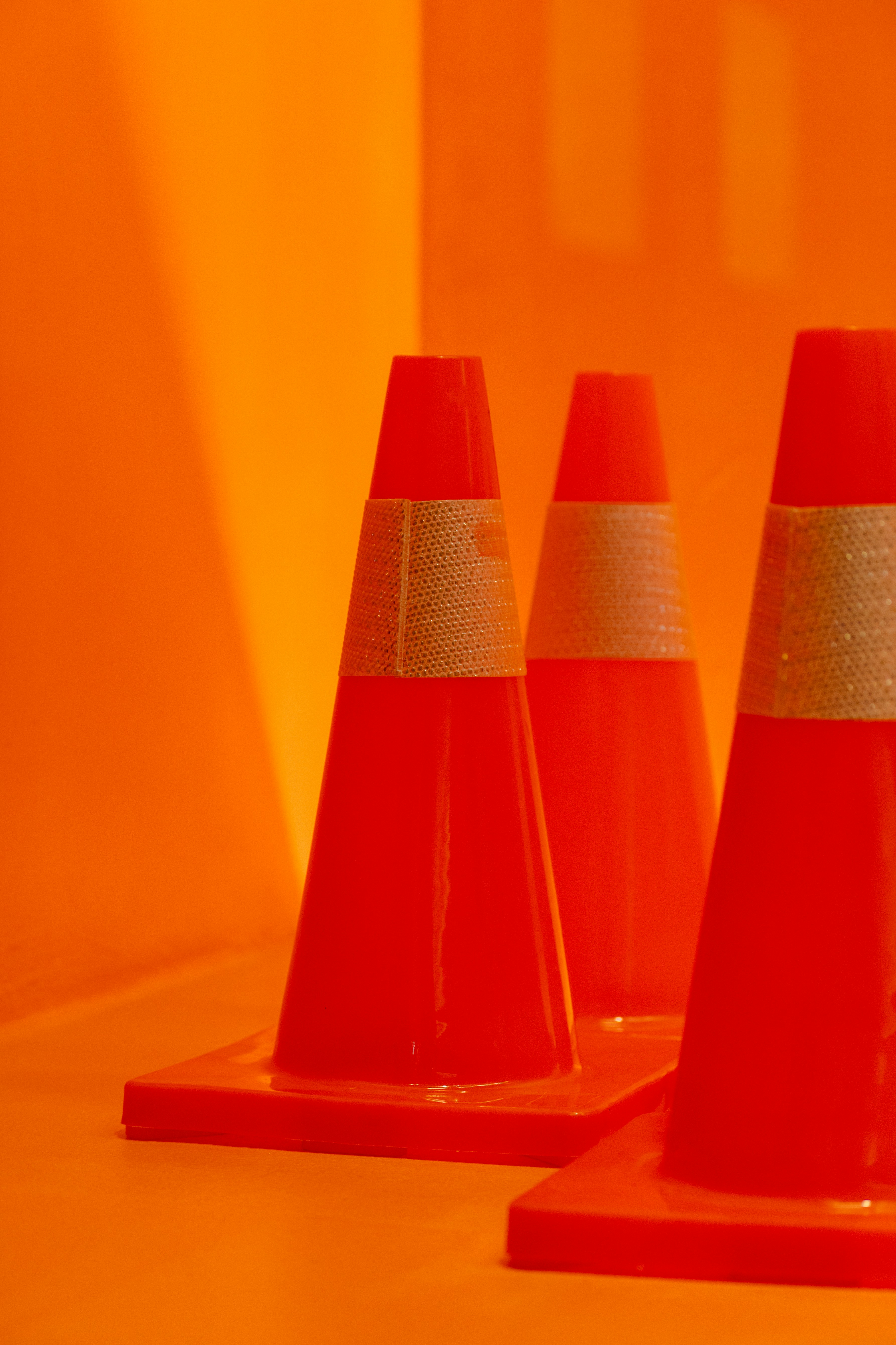 a group of orange traffic cones sitting on top of a table