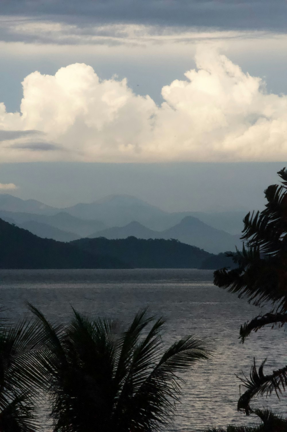 a body of water with mountains in the background