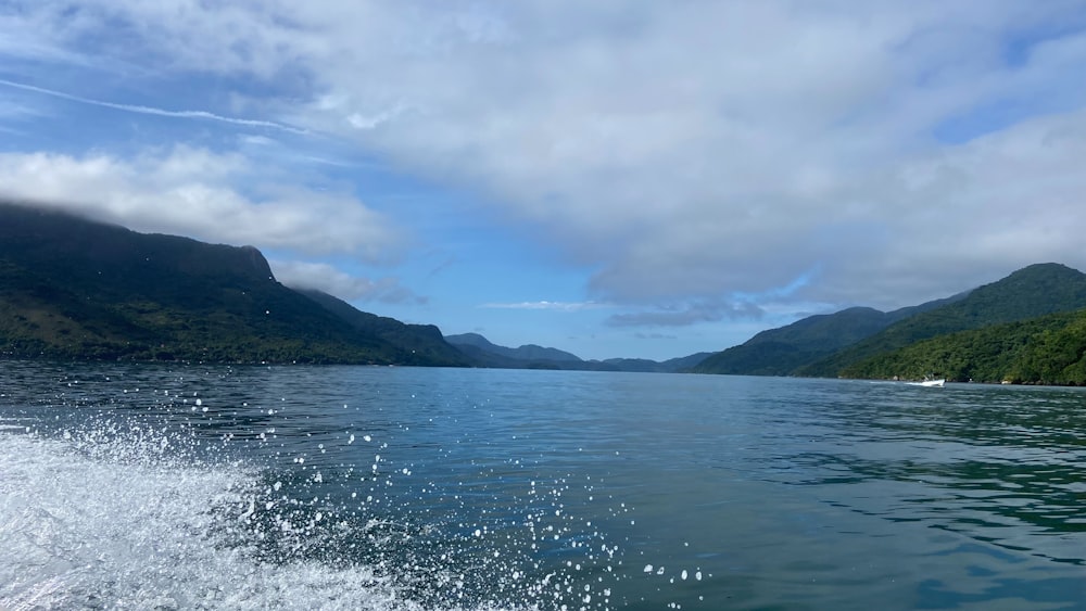 a body of water with mountains in the background