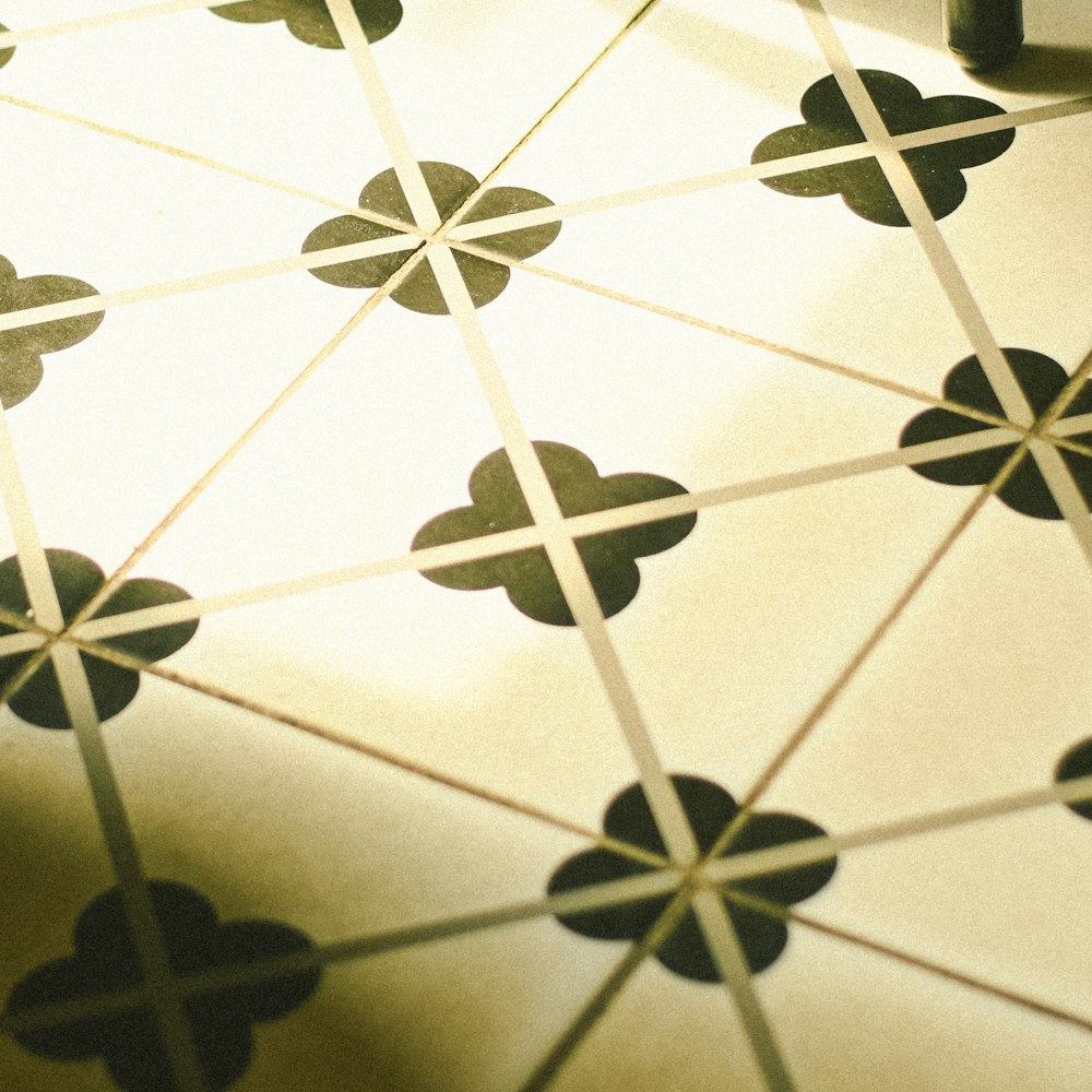 a close up of a tiled floor with black and white designs