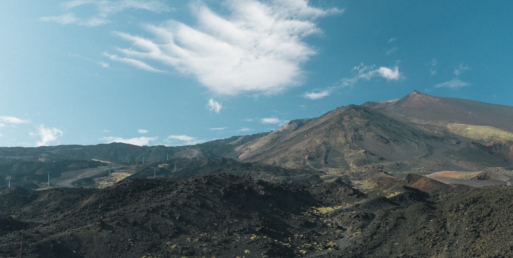 a view of a mountain with a blue sky in the background