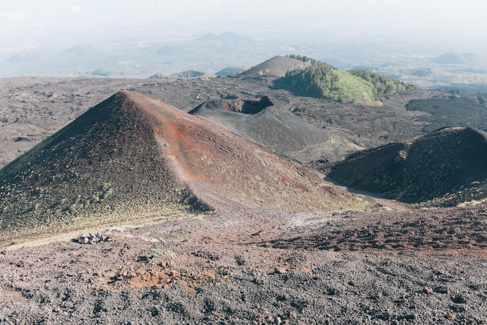 a view of a mountain range from the top of a hill