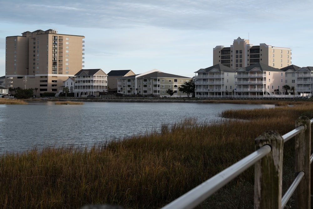 a body of water next to a row of buildings